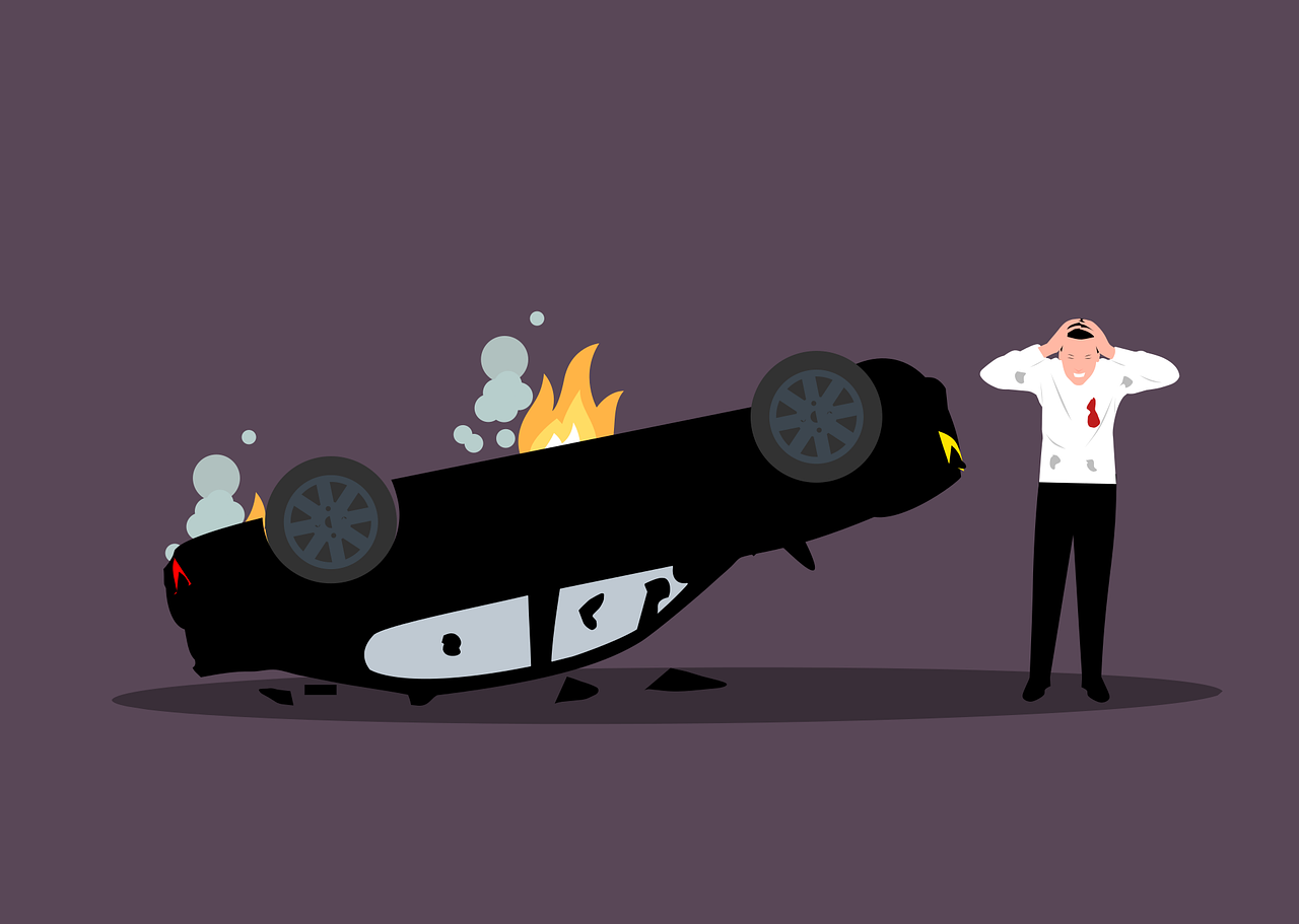 man standing next to wrecked car